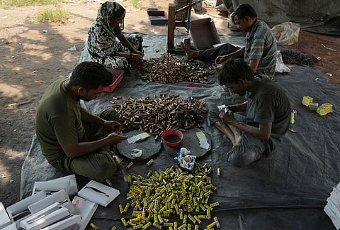 Workers make firecrackers for the upcoming Hindu festival of Diwali at a factory on the outskirts of Ahmedabad,  Tuesday, Oct. 27, 2026. 
