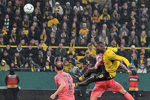 Dortmund's Serhou Guirassy jumps for the ball during the German soccer cup match between Borussia Dortmund and Werder Bremen in Dortmund, Germany, Tuesday, Oct. 27, 2026.