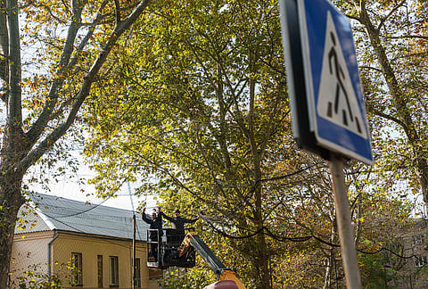 Municipal workers stretching anti-drone nets over a street during a local ceasefire related to a humanitarian aid mission in Oleshky, in Kherson, Ukraine, Wednesday, Oct. 28, 2026. 
