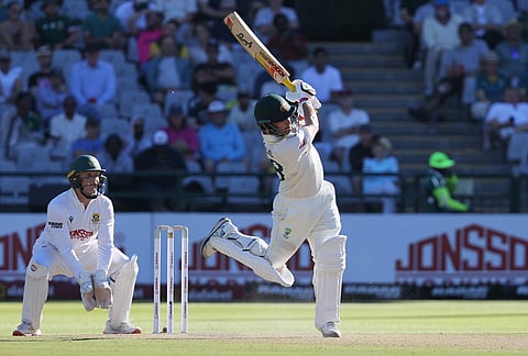 Australia's Josh Inglis plays a shot as South Africa's wicketkeeper Ryan Rickelton watches on day two of the third cricket test match between South Africa and Australia, in Cape Town, South Africa, Wednesday, Oct. 28, 2026.
