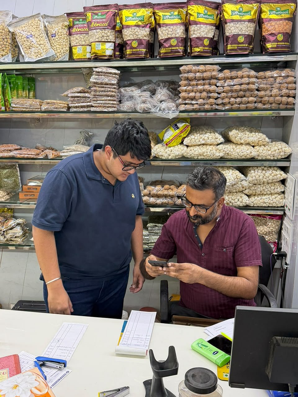 Hridhay Kanodia with a shopkeeper - null