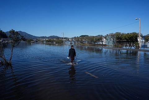 A woman wades through a flooded road in Sausalito, California, Wednesday, Oct. 28, 2026. 