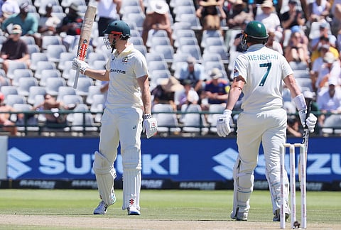 Australia's Cameron Green, right, celebrates his fifty as Australia's Matt Renshaw watches on day two of the third cricket test match between South Africa and Australia, in Cape Town, South Africa, Wednesday, Oct. 28, 2026. 