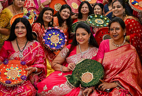 Women from the Agrawal community participate in a thali decoration event ahead of the 'Karva Chauth' festival, in Bhopal, Madhya Pradesh, Monday, Oct. 26, 2026. 
