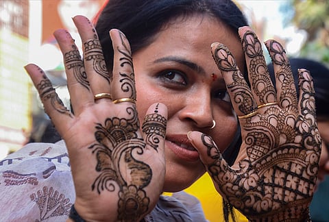 A woman gets henna designs applied ahead of the 'Karva Chauth' festival, in Kanpur, Uttar Pradesh, Wednesday, Oct. 28, 2026. 