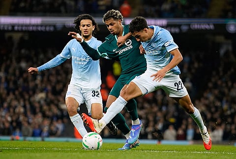 Brighton's Georginio Rutter, center, challenges for the ball with Manchester City's Ayyoub Bouaddi, left, and Manchester City's Vitor Reis during the English League Cup soccer match between Manchester City and Brighton and Hove Albion in Manchester, England, Wednesday, Oct. 28, 2026. 