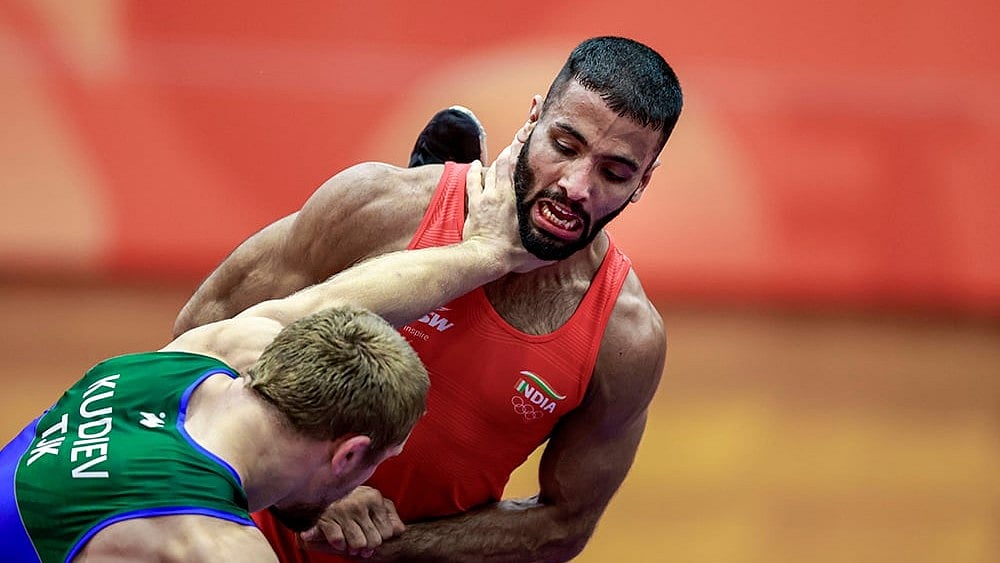 India's Sujeet Kalkal, right, competes in the men's Freestyle 65 kilogram final bout 196 wrestling match against Tajikistan's Abdulmazhid Kudiev in the ongoing Asian Games 2026, in Nagoya, Japan, Friday, Oct. 2, 2026.
 - | Photo: PTI/Arun Sharma