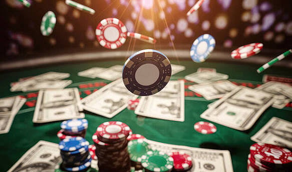 Casino chips falling over cash on a green table