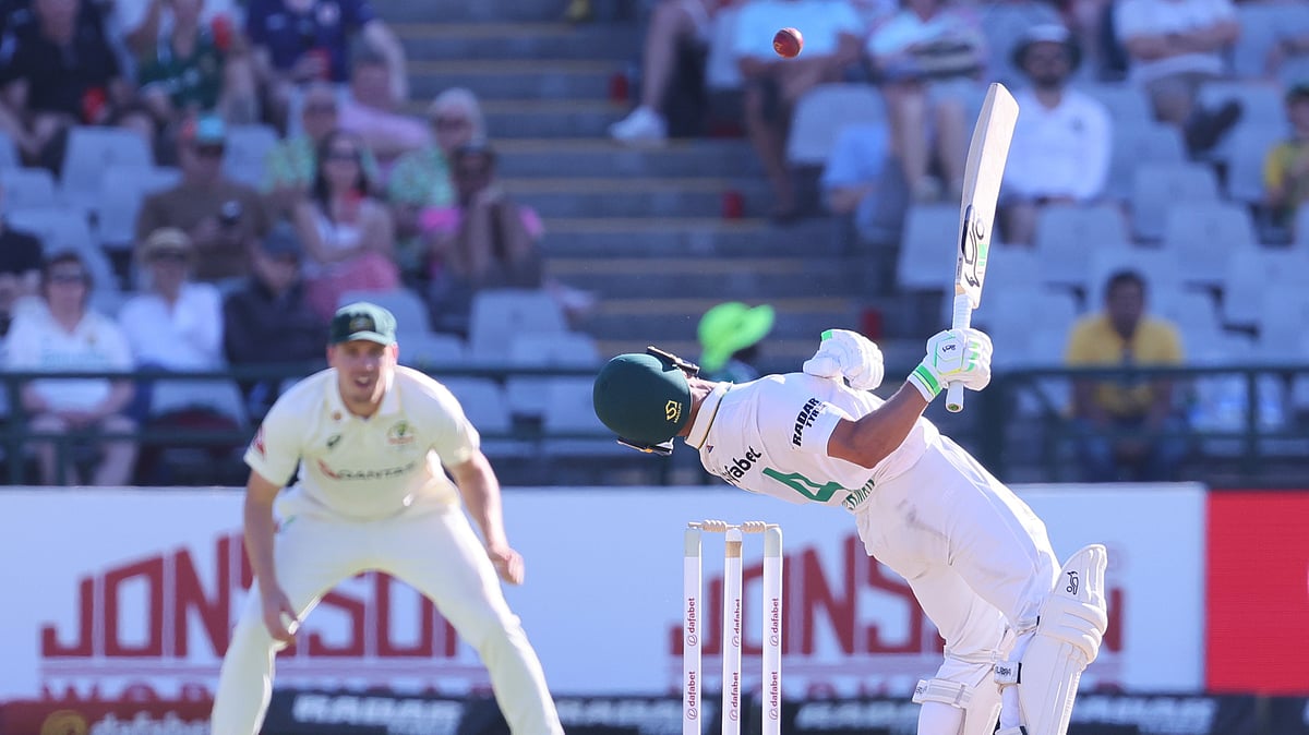 South Africa's Marques Ackerman, right, ducks from a high ball as Australia's Cameron Green looks on, on day three of the third cricket test match between South Africa and Australia, in Cape Town, South Africa, Thursday, Oct. 29, 2026. - (AP Photo/Halden Krog)