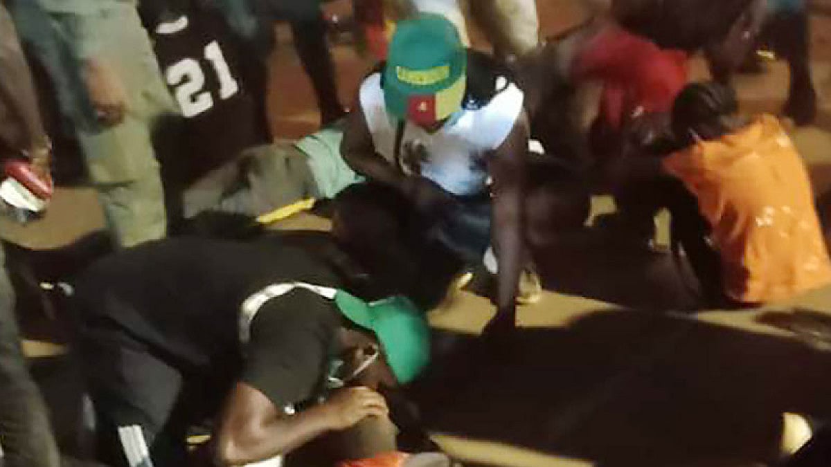 People assist victims of a stampede at a African Cup of Nations game in Yaounde, Cameroon.