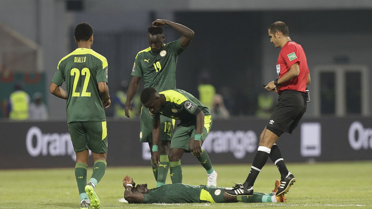 Senegal's Saido Mane lays on the pitch following a collision.
