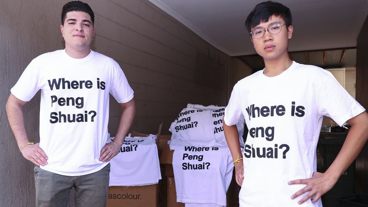 Drew Pavlou (L) and Max Mok show 1000 shirts they plan to distribute to Australian Open spectators.