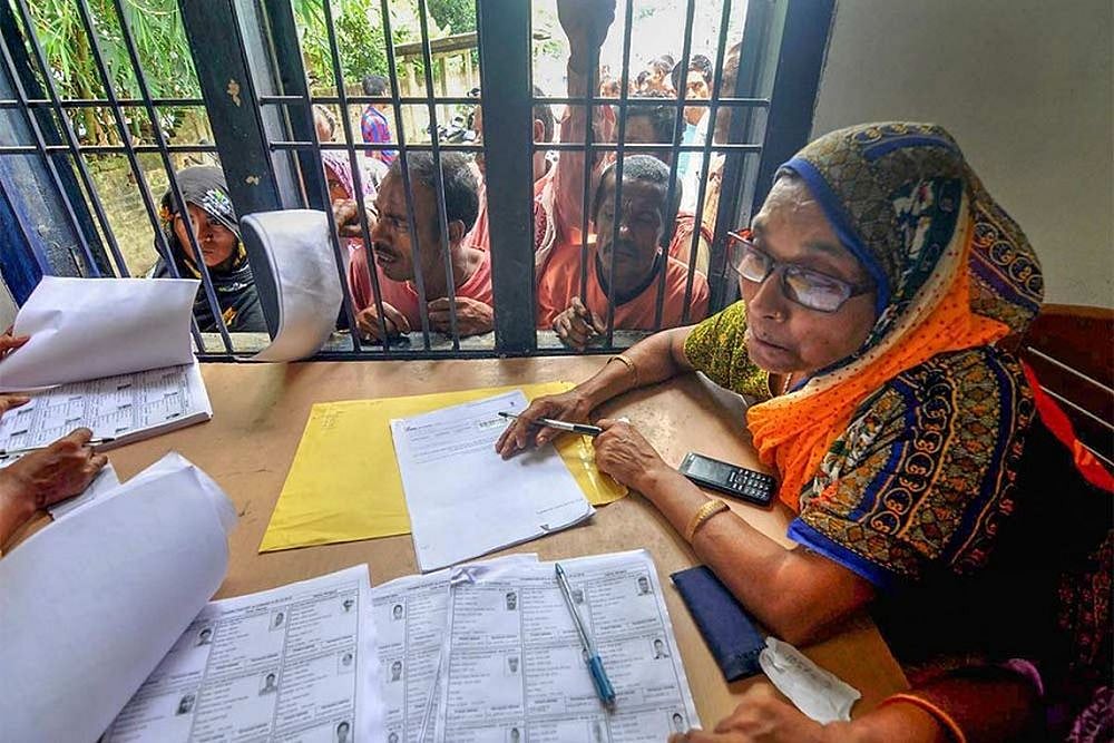 People wait in a queue to check their names on the final draft of the states National Register of Citizens after it was released, at an NRC Seva Kendra, in Morigaon.
