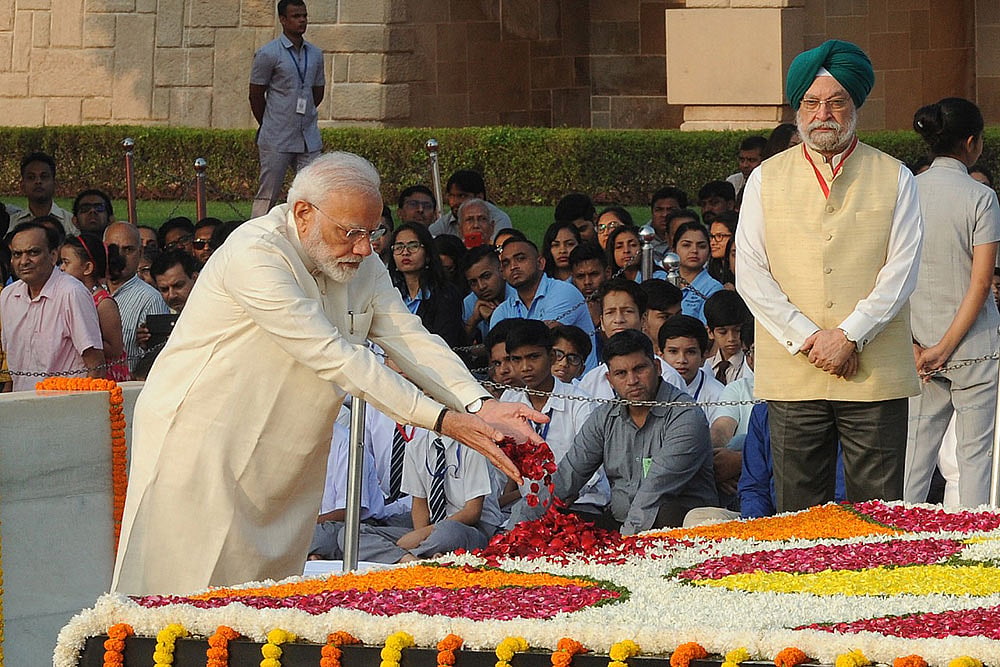 Prime Minister Narendra Modi pays tribute to Mahatma Gandhi at Raj Ghat. 