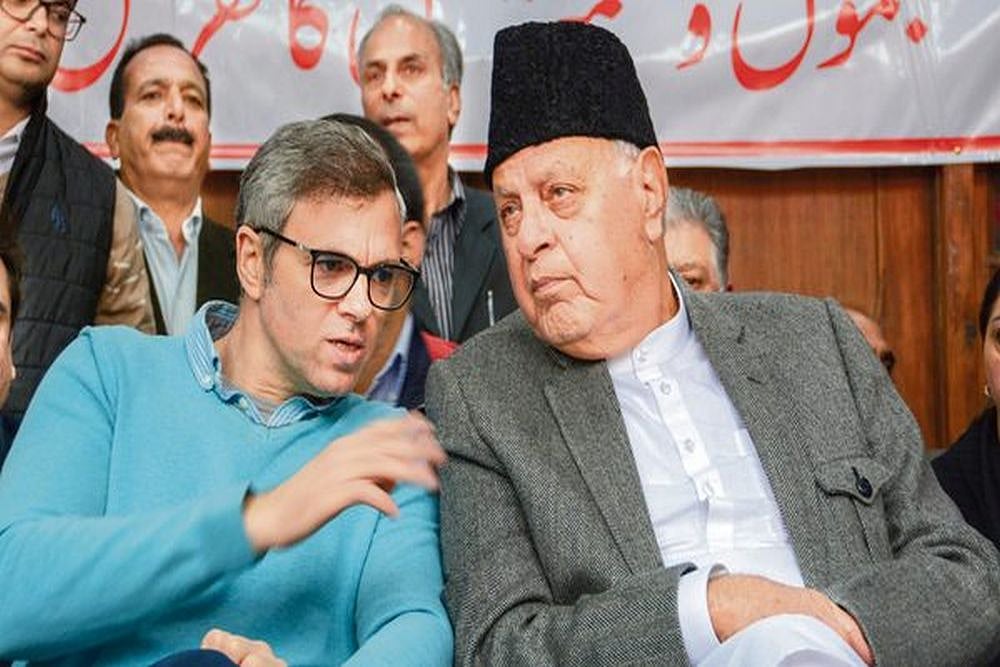 National Conference leaders Farooq Abdullah (R) and Omar Abdullah (L)