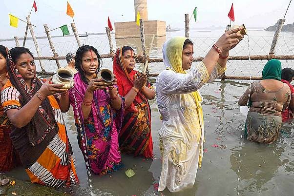 Devotees offer prayers after taking a holy dip in the Ganga river during ‘Nahay Khay’ Puja of the Chhath Puja festival, in Patna.