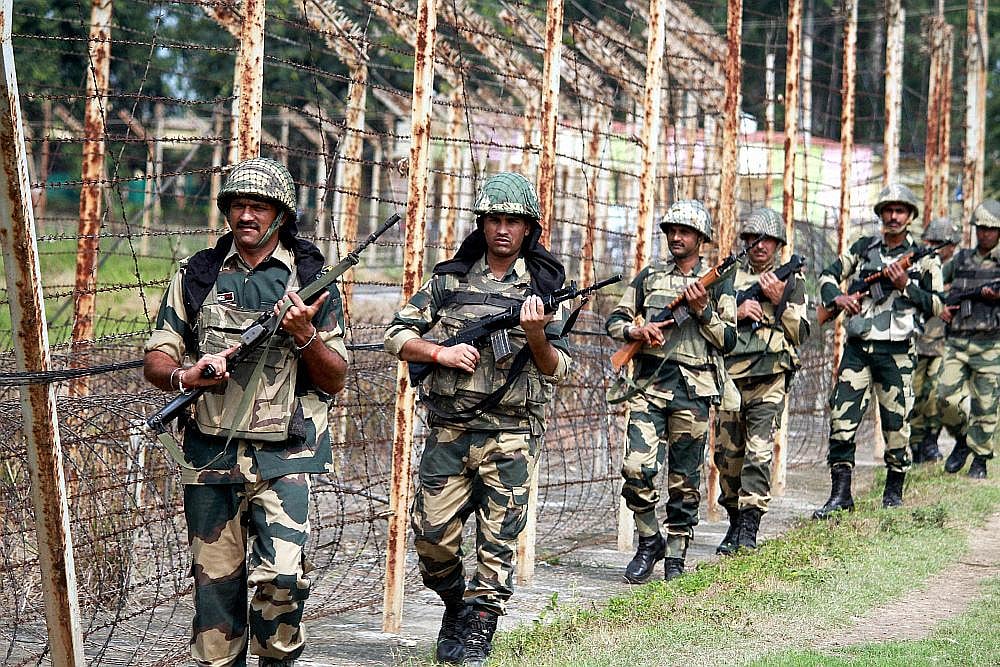 BSF personnel patrol along thw international border (IB) at Octroi post in Jammu, J&K.