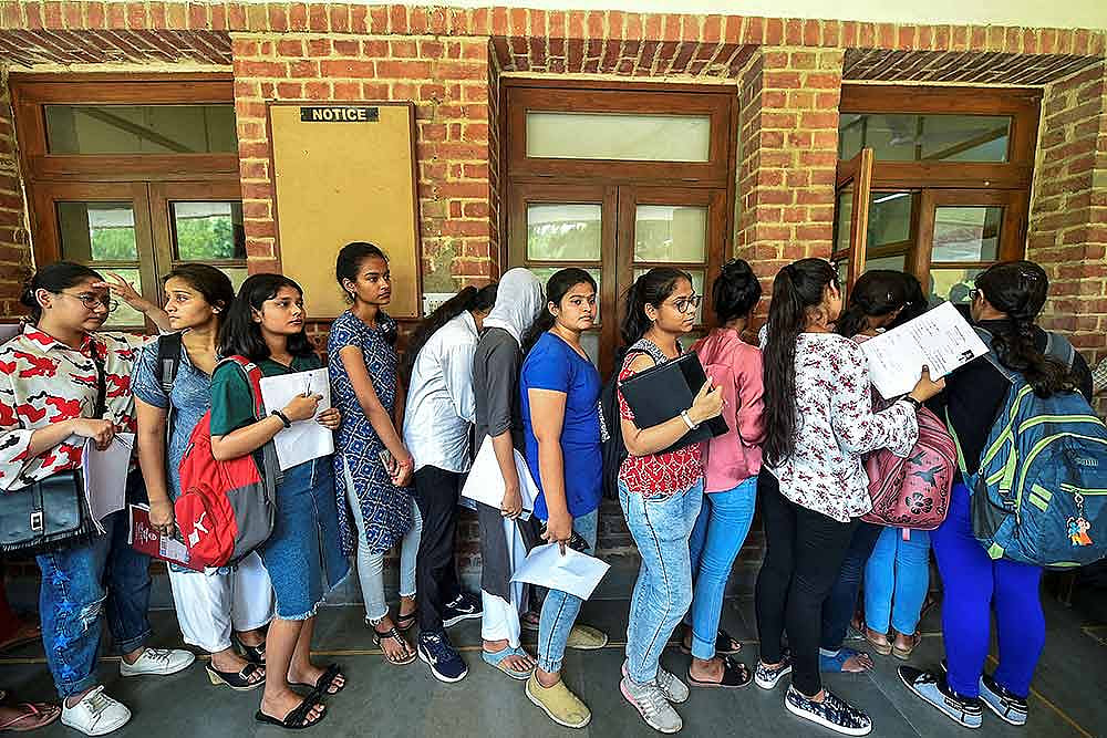 Students queue as they wait to fill their admission forms at Hindu College, in New Delhi.