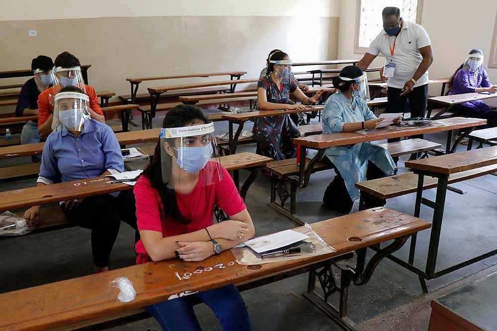 Students wearing protective shields appear in IIT entrance examination, in Ahmedabad.