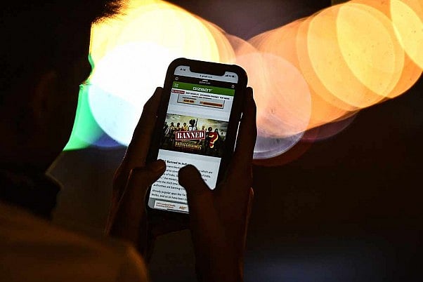A man reads news on his mobile phone after the government blocked 118 more mobile applications, including popular gaming app PUBG, terming them prejudicial to the sovereignty, integrity and defence of the nation