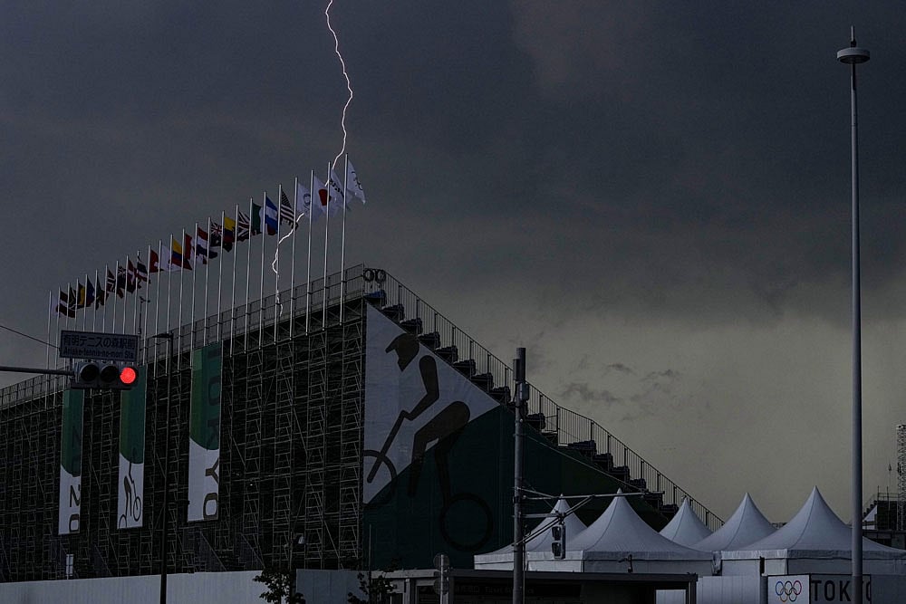 A lightening is seen behind Ariake Urban Sports Park, where Olympic Cycling BMX freestyle, BMX racing and skateboarding will be held, Sunday, July 11, 2021, in Tokyo. Skateboarding will make its Olympic debut in Tokyo.