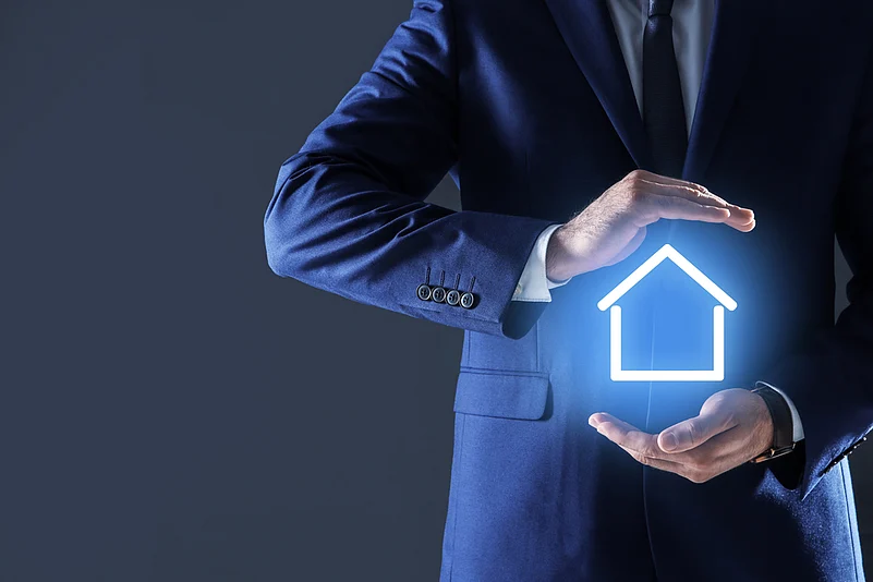 A man holding a glowing house insignia
