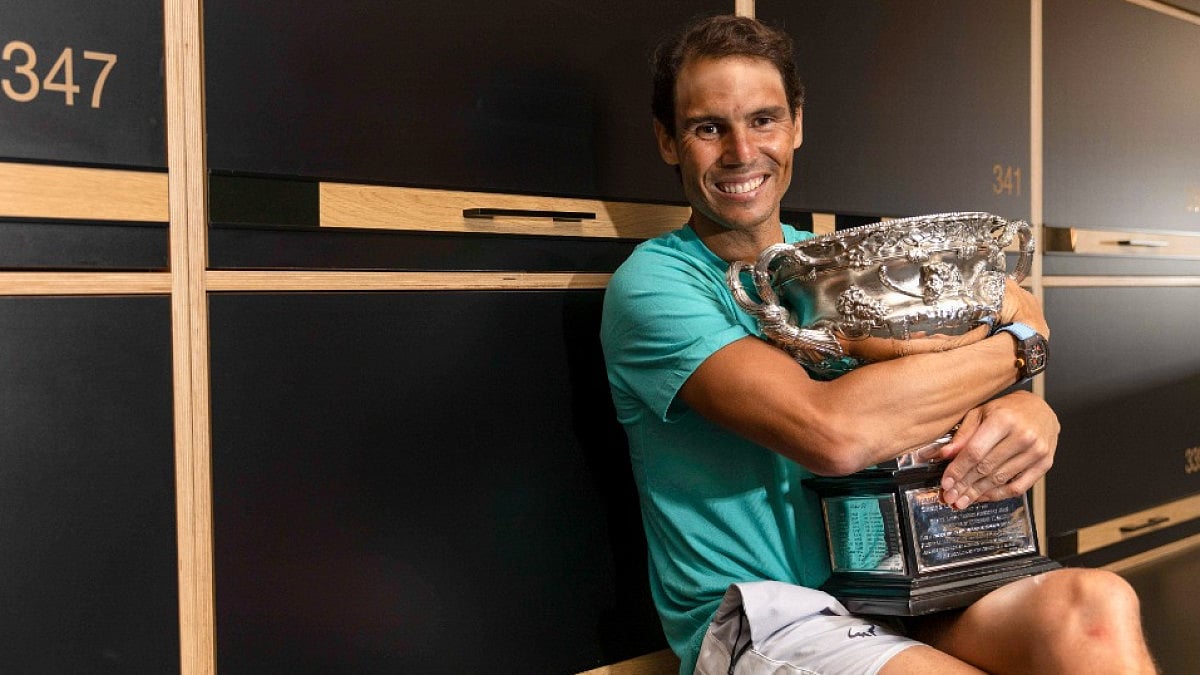 Rafael Nadal poses with the Australian Open 2022 trophy in the locker room at Melbourne Park.