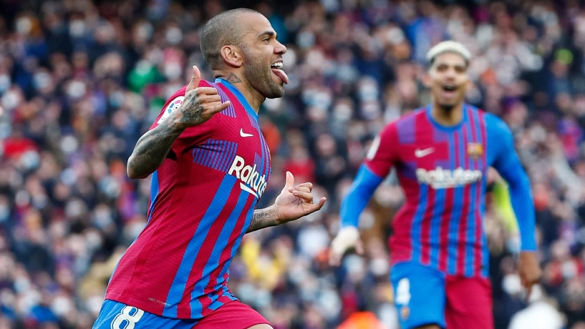 Barcelona's Dani Alves (L) celebrates after scoring against Atletico Madrid in  La Liga 2021-22.