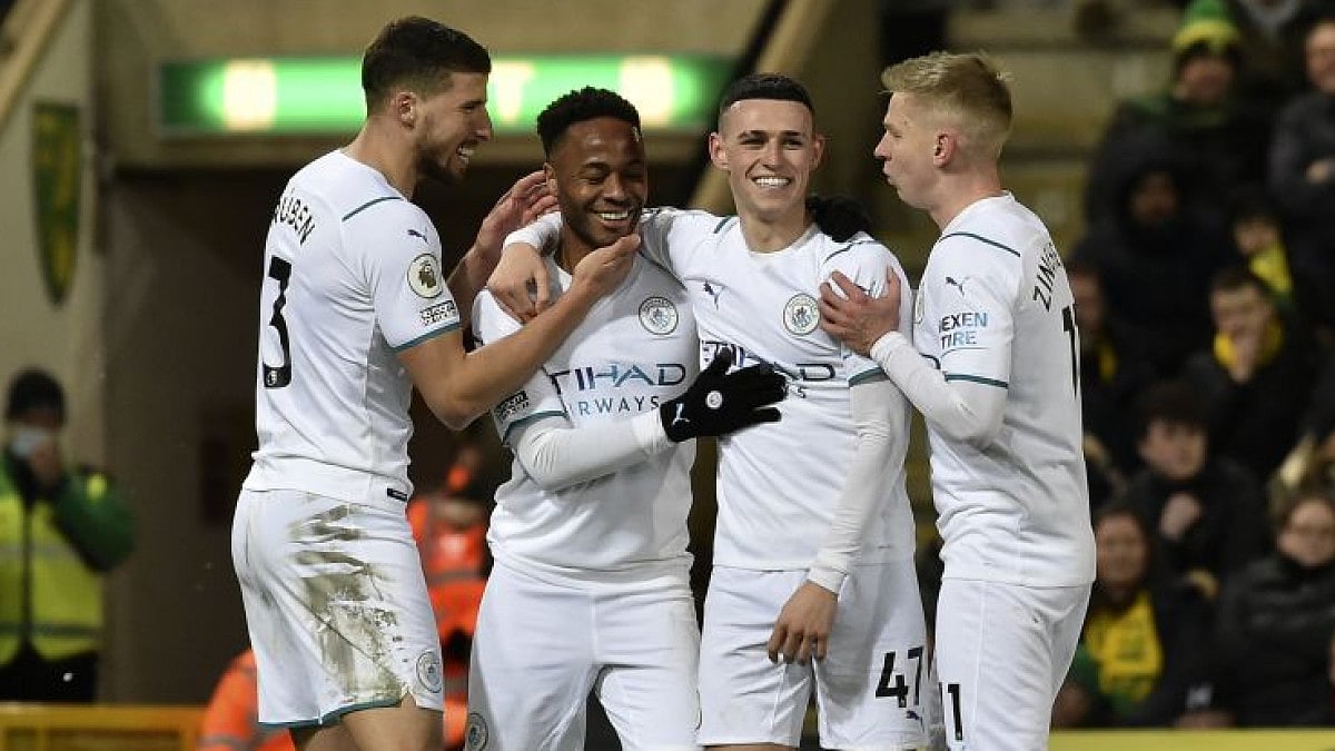 Manchester City's Raheem Sterling celebrates with teammates after scoring his side's third goal.
