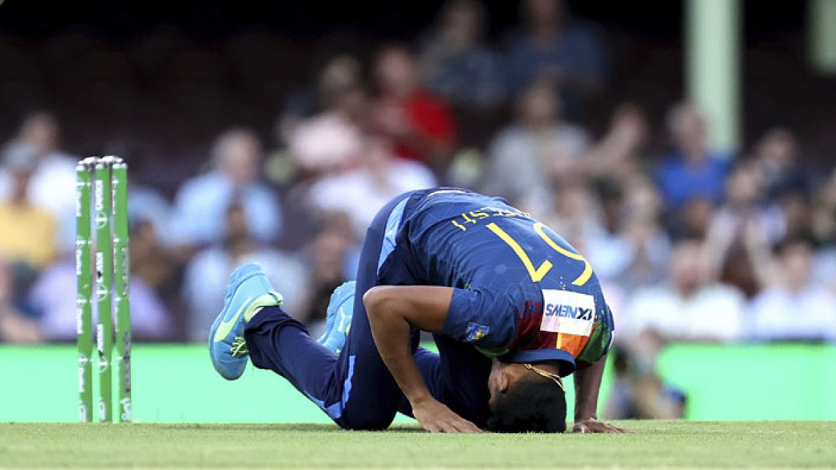 Maheesh Theekshana of Sri Lanka falls to the ground during a match against Australia in Sydney.