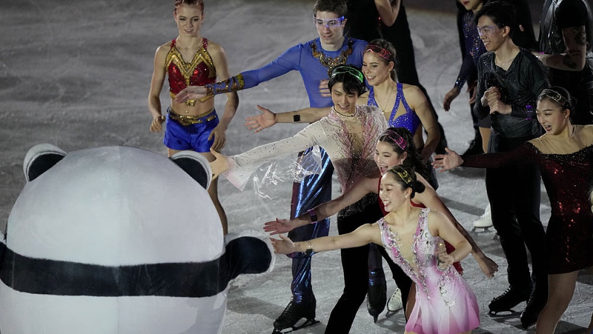 Japan's Yuzuru Hanyu performs with the mascot during figure skating gala at 2022 Winter Olympics.