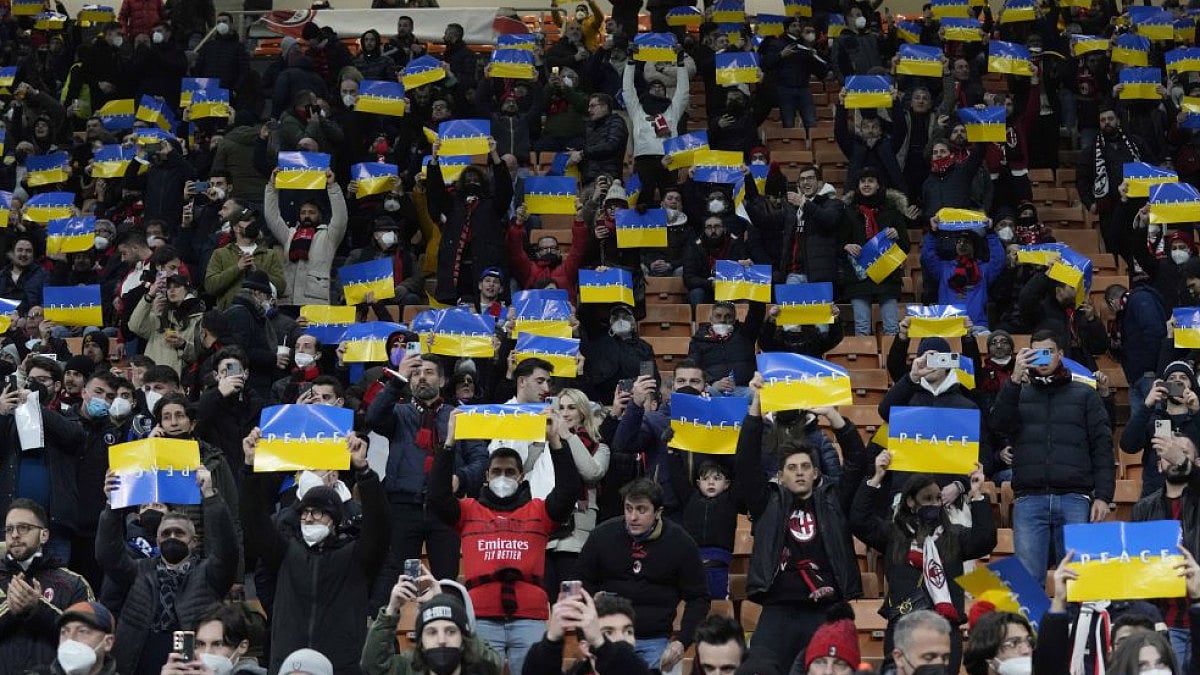 Spectators hold banners that reads 'Peace' ahead of AC Milan Vs Inter Milan Coppa Italia semifinal.