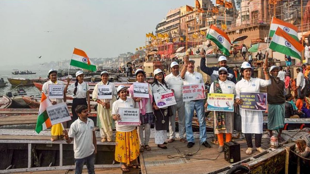 Volunteers hold the national flag during an awareness campaign on voting, in Varanasi.
