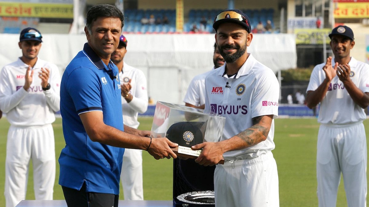 Virat Kohli receives his 100th Test cap from Rahul Dravid on Friday in Mohali.  