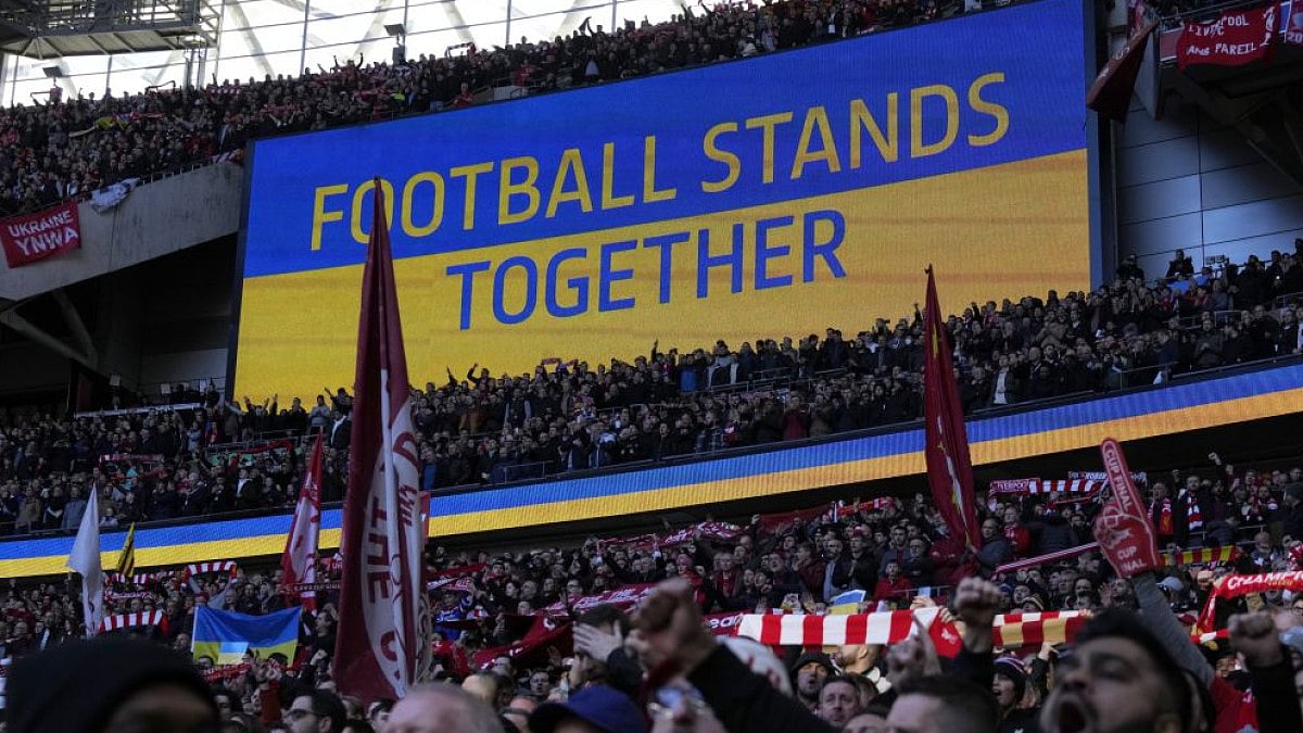 A video screen displays Ukrainian flag in English League Cup final between Chelsea and Liverpool.