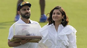 File : India's Virat Kohli and his wife Anushka Sharma pose during a facilitation ceremony in Mohali.