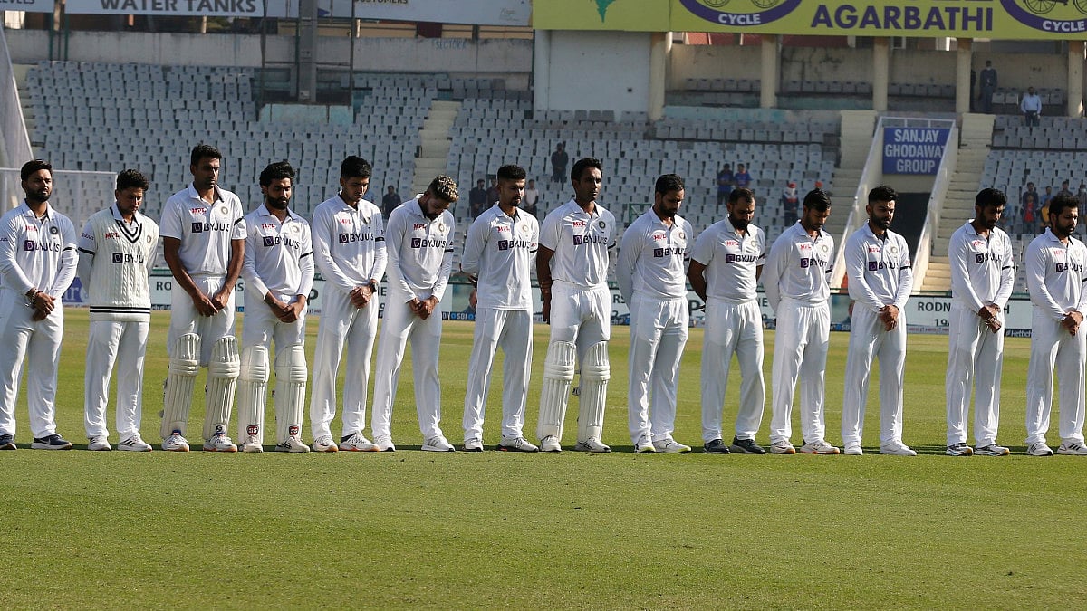Indian players observing a minute's silence to honour the memory of Shane Warne and Rodney Marsh.