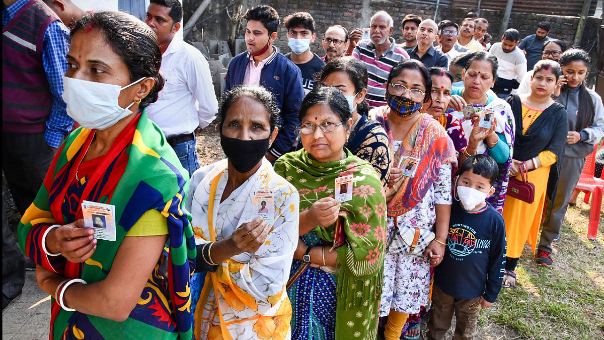 Voters stand in a queue to cast their votes at a polling station for the municipal polls.