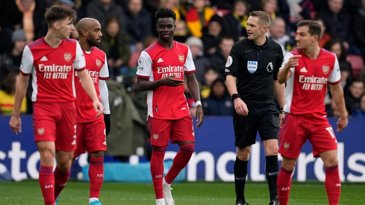 Arsenal's Bukayo Saka (C) celebrates with teammates after scoring against Watford in Premier League.
