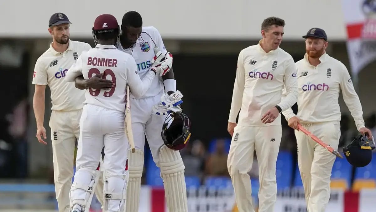 Jason Holder, Nkrumah Bonner embrace after Day 5 of first Test match against England.