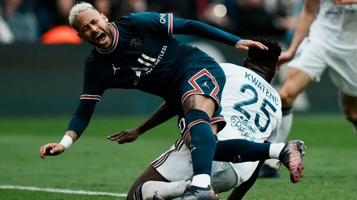 PSG's Neymar is tackled by Bordeaux's Enock Kwateng during the Ligue 1 2021-22 match in Paris.