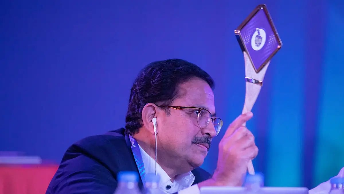 Kolkata Knight Riders CEO Venky Mysore lifts the paddle during an IPL auction.  