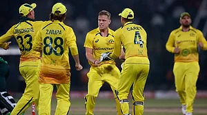 Australia players celebrate the fall of a Pakistan wicket in the first ODI in Lahore.