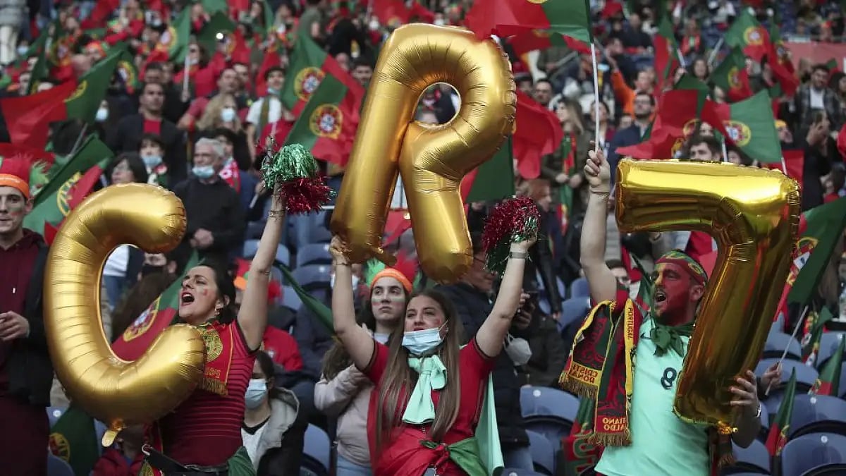 Fans hold up balloons for Cristiano Ronaldo in stands ahead of Portugal vs North Macedonia match.