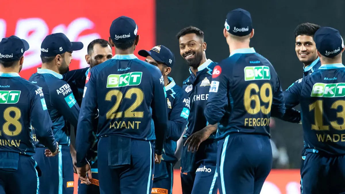 Gujarat Titans players celebrate the fall of a Delhi Capitals wicket during their IPL 2022 match.