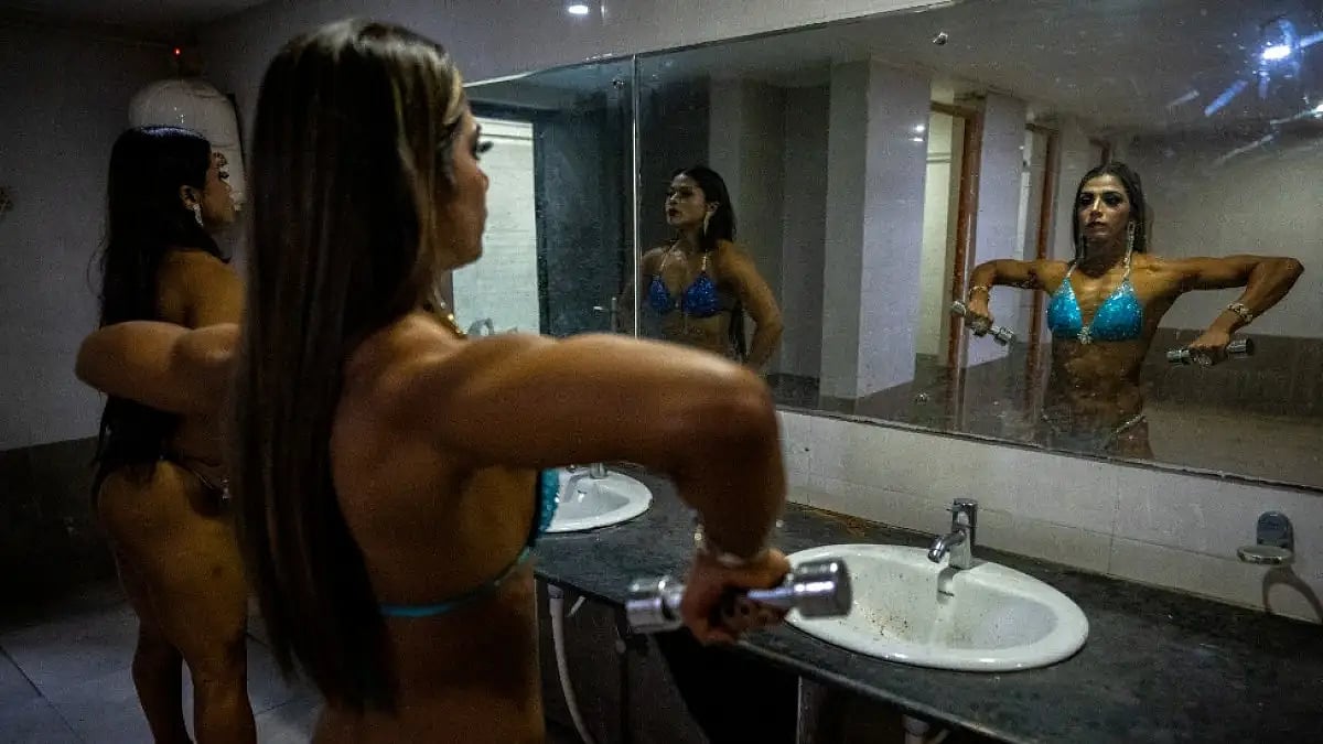 Female body builders prepare backstage before Miss Saraighat Body Building Championship. 