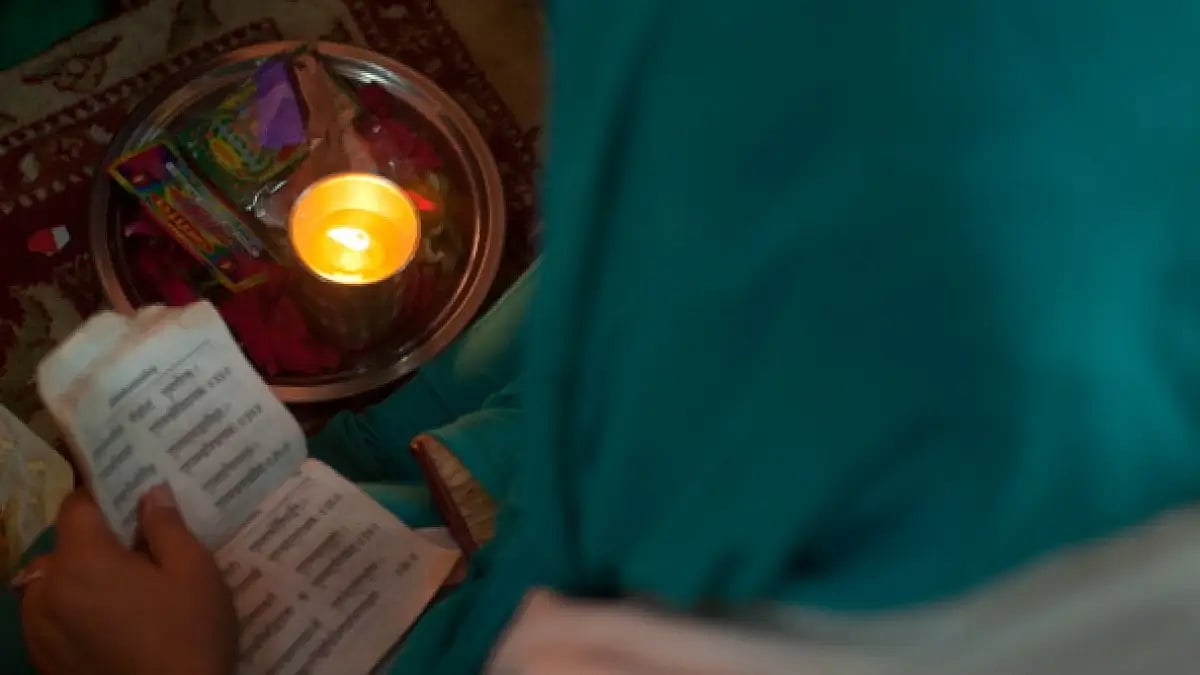 A Kashmiri Pandit devotee reads Hindu scripture during the annual Hindu festival of Kheer Bhawani.