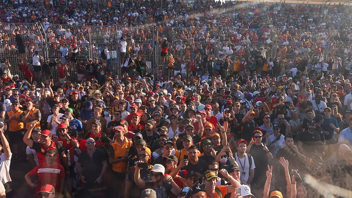 Fans flood onto the track after the conclusion of AUS GP in Melbourne on Sunday.