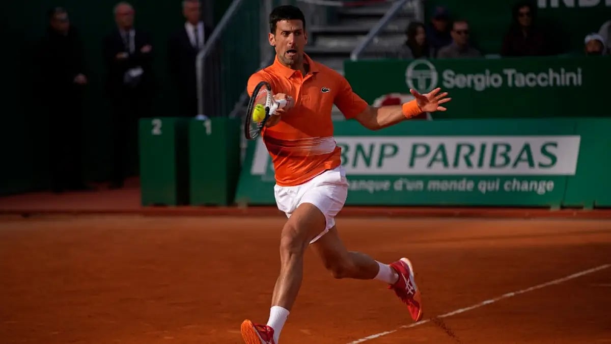 Novak Djokovic returns to Davidovich Fokina during their  Monte Carlo Masters encounter.