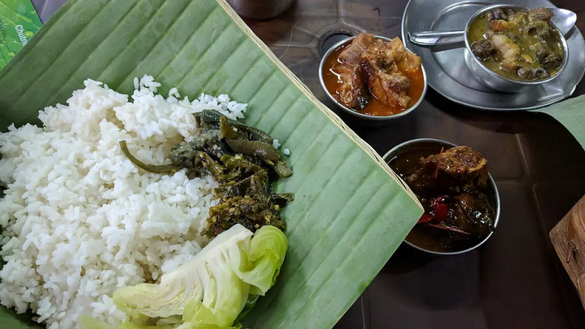 Naga meal of rice, vegetables, soup, chutney, boiled cabbage, pork with akhuni, beef, chicken curry